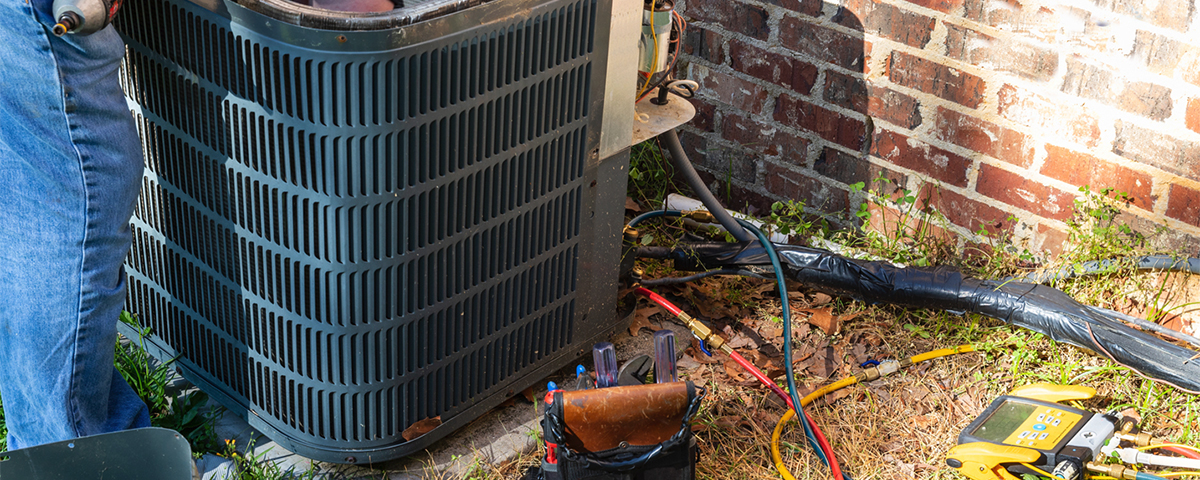 repairman fixing air conditioner